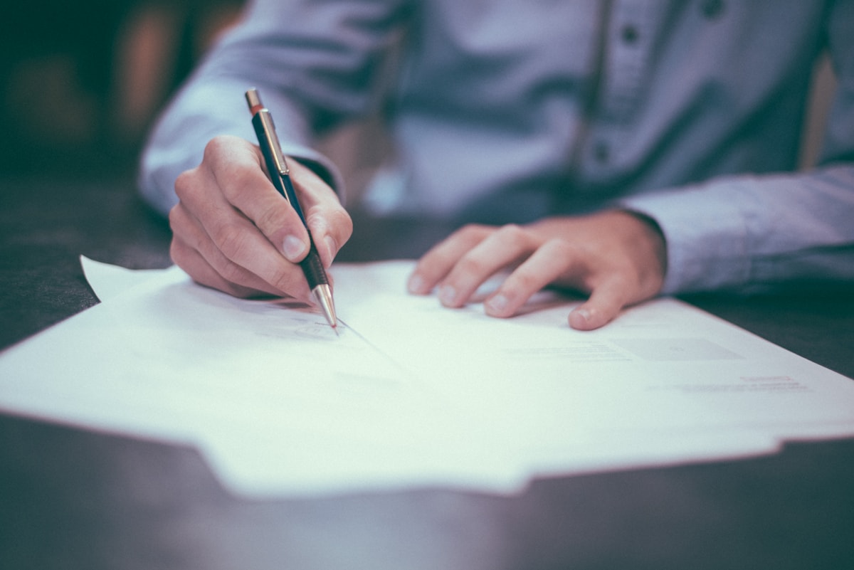 Person signing business paperwork